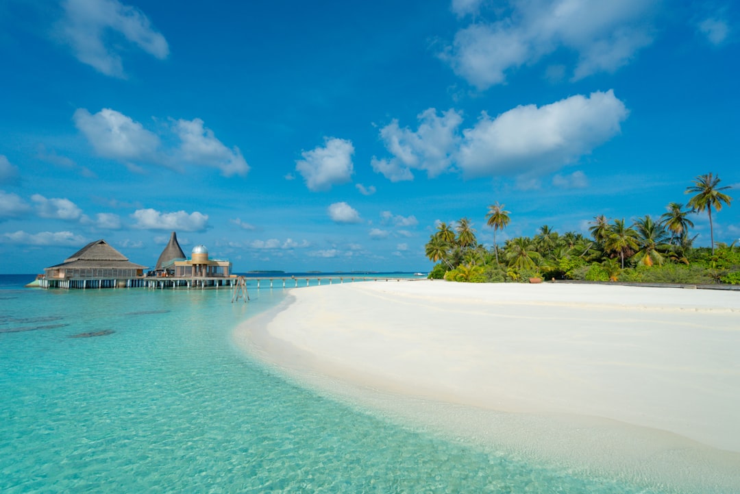 Turquoise lagoon with overwater bungalows under clear blue sky