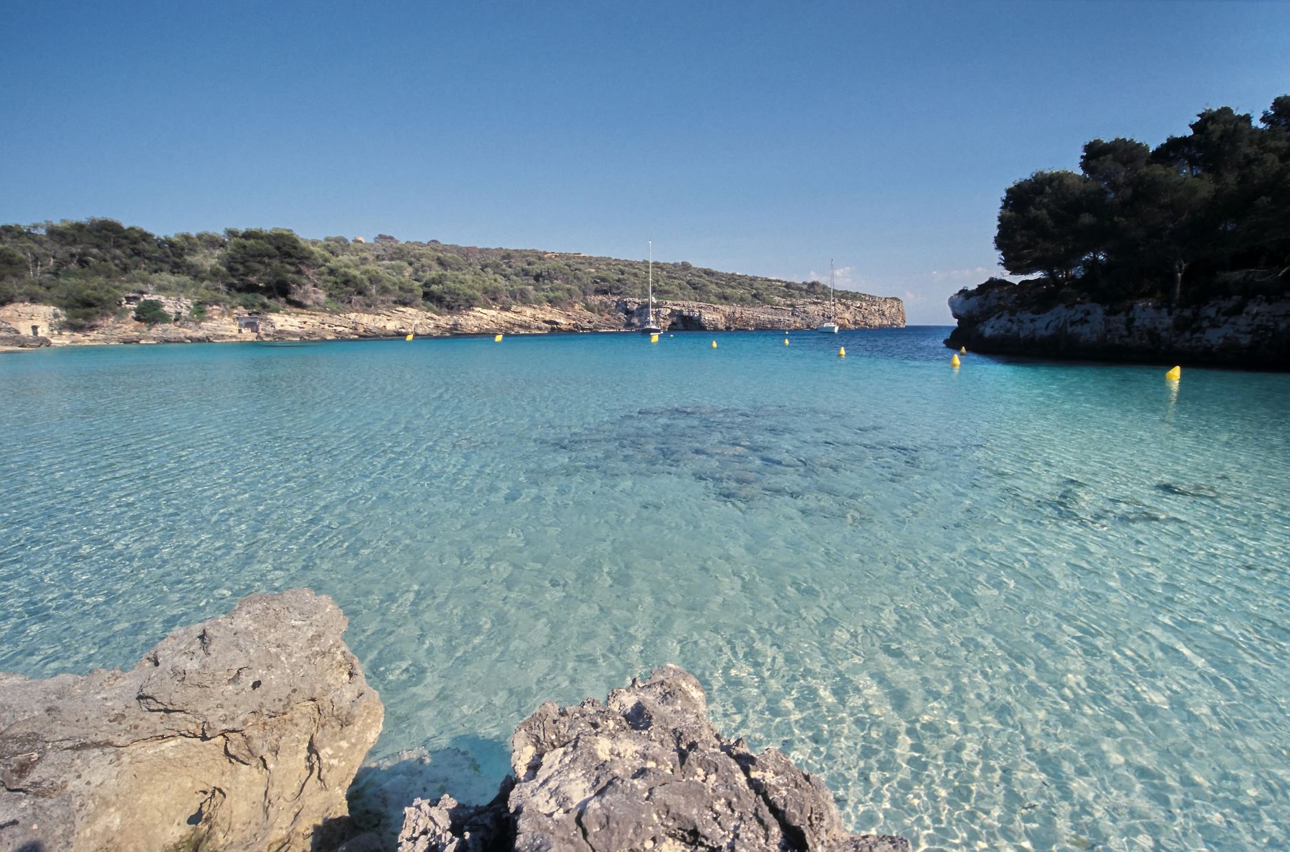 Turquoise water and white sand beach in a protected cove on Menorca
