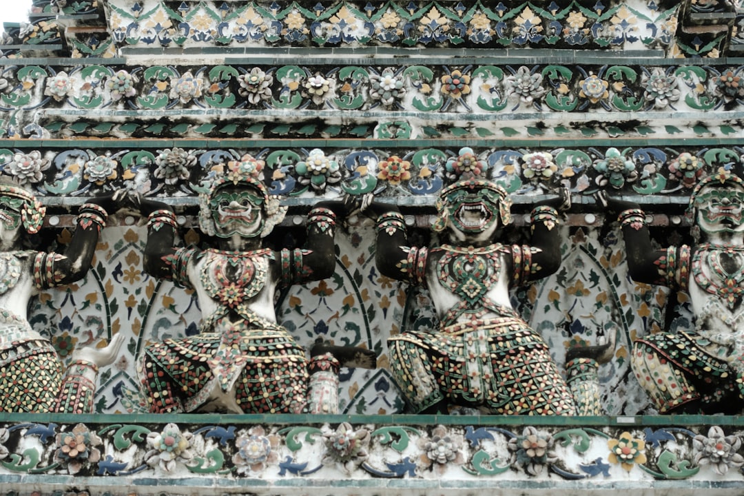 Wat Arun's central prang is decorated with porcelain shards, a technique that catches light differently through the day.
