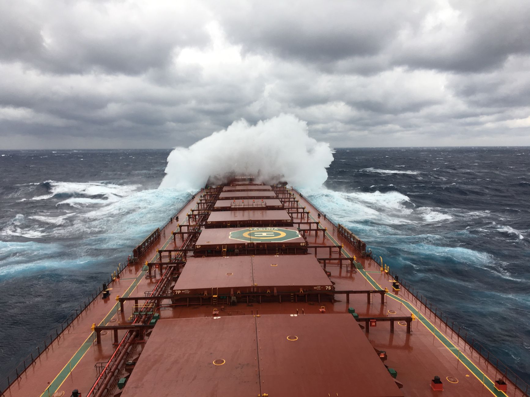 Waves breaking over the lower deck rail during a rough stretch of the crossing.