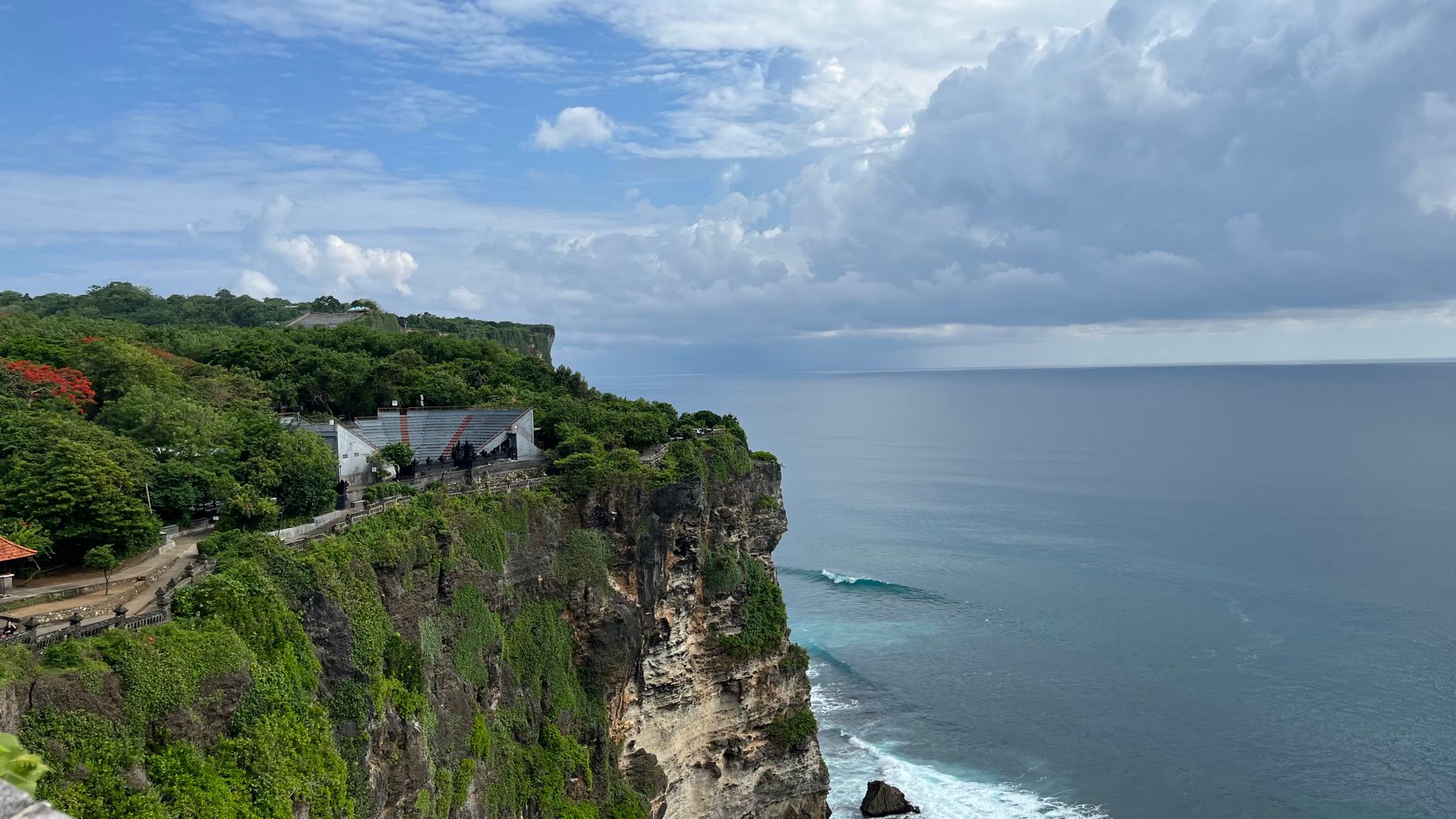 Wedding arch set on a limestone cliff overlooking the ocean in Uluwatu, Bali at sunset