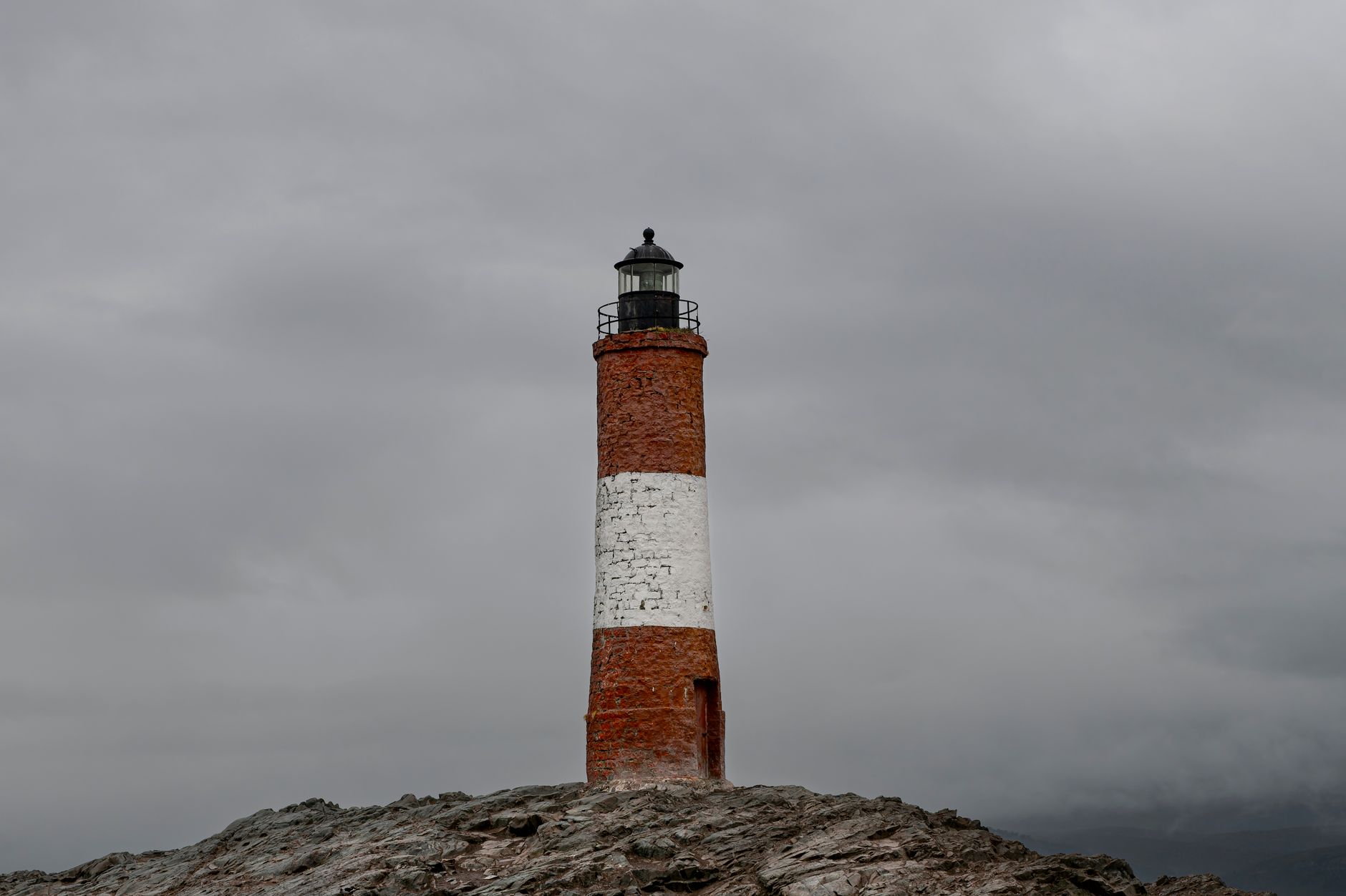 White lighthouse on rocky outcrop in rough southern seas