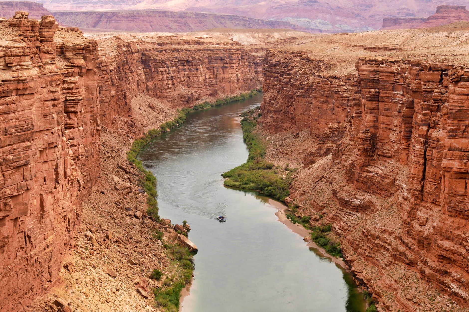 Whitewater rapids with red sandstone canyon walls on the Colorado River in Utah